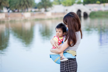 Mother and her child enjoy the summer in green park outdoor.