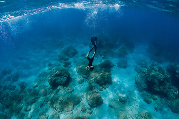 Fototapeta na wymiar Professional freediver in wetsuit dive in the ocean
