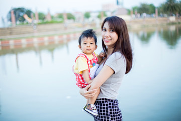 Mother and young son having fun in the park