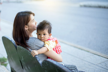 The mother carries the child in her arms