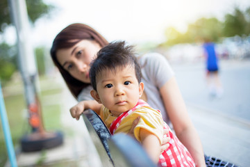 Beautiful Mother And Baby outdoors. Nature. Beauty Mum and her Child playing in Park together.