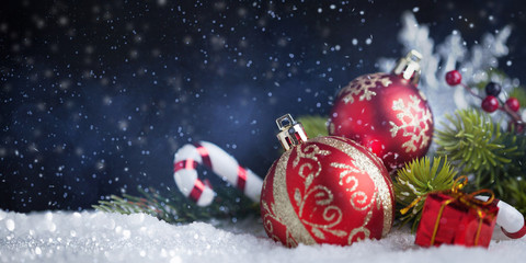 Christmas balls and decoration on snow. New Year's card