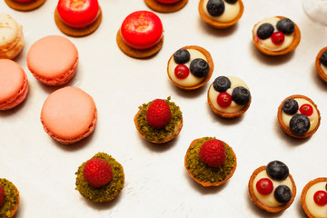 Delicious tartlets filled with fruits macarons
