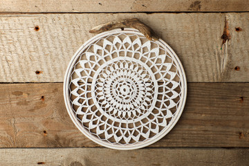 Macrame, mandala, dream catcher, shabby chic, copy space. Wedding or relaix time background. Crocheting mandala on vintage wooden background