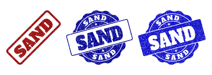 SAND scratched stamp seals in red and blue colors. Vector SAND labels with grainy surface. Graphic elements are rounded rectangles, rosettes, circles and text labels.