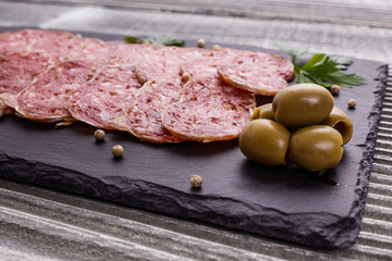 Saucisson sec delicious french salami on a wooden background