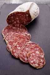 Saucisson sec delicious french salami on a wooden background
