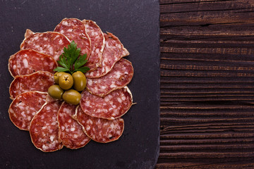 Saucisson sec delicious french salami on a wooden background