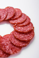 delicious sliced salami on a white background