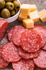 delicious sliced salami on a wooden background