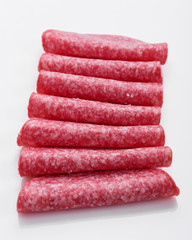 delicious sliced salami on a white background