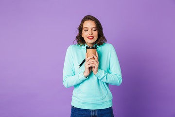 Fototapeta premium Beautiful young woman posing isolated over purple background wall.