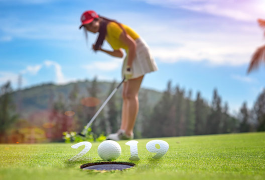incomming year 2019, prepare by putting of woman golfer on the green,  golfball mostly ready to drop into the hole of new year success, Happy new year and merry Christmas on golf course