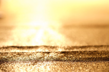 Abstract Sprinkle glitter gold dust on black background textured ,elegant and luxury concept