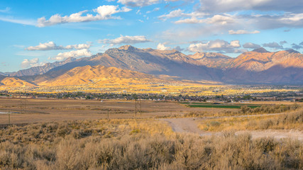 Homes near mountain under sunny sky in Utah Valley