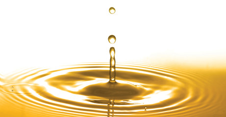 Liquid gold or olive oil drop and ripple wave,abstract background