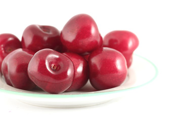 A plate of cherry isolated on white background