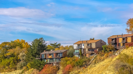 Fototapeta na wymiar Homes on a hill in Salt Lake City against blue sky