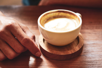 Latte art coffee on wooden table on coffee time