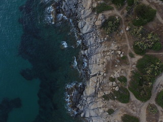 Aerial photography of the Sardinia coast during a summer sunset. Small waves on the rocks taken with a drone.
