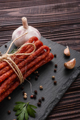 kabanos delicious polish snack sausage on a stone plate wooden background