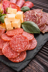 Cold smoked meat plate on a rustic wooden background