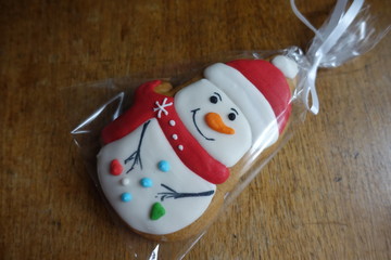 Glazed ginger bread snowman on wooden table