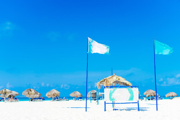 Beautiful tropical beach and Caribbean sea with sunbeds