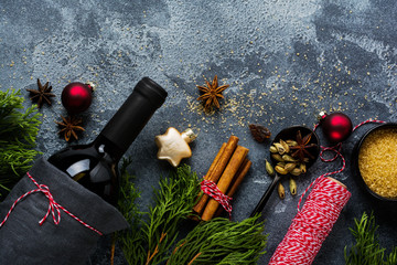 New Year food background. Ingredients for making Christmas mulled wine (bottle of red wine, orange, cane sugar and spices). Top view.