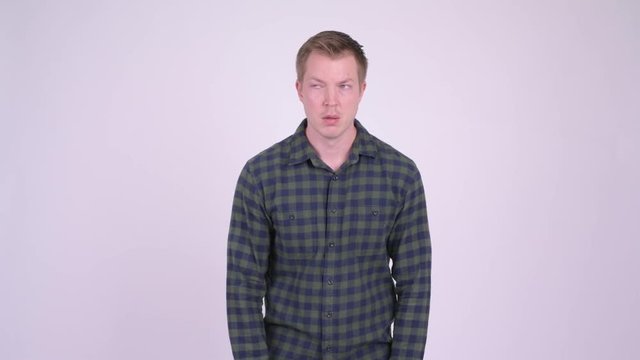 Young sad man doing various gestures while looking depressed