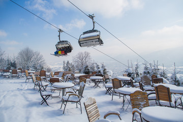 Outdoor mountain cafe in winter season,  Poland, ski resort Zakopane, Polana Szymoszkowa, mountains of Polish Tatras © polya_olya