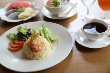 Fried rice with shrimp on wooden table