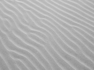 Fototapeta na wymiar gray sand wave ripple at the beach