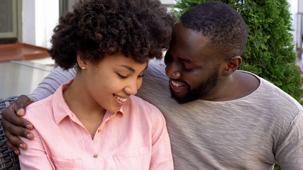 Obraz premium Smiling newlyweds looking each other with love, relaxing outside house, date