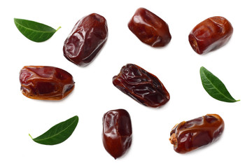 date fruits with green leaves isolated on white background. top view