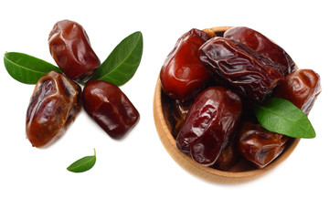 date fruits with green leaves isolated on white background. top view