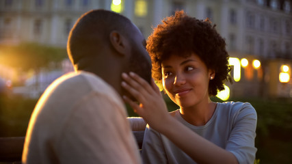 Young lady tenderly stroking boyfriends face, love expression, romantic date