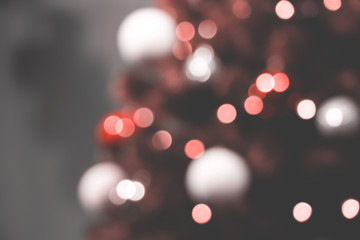 Christmas tree and holiday decorations. Blurred defocused background in colour of Living Coral