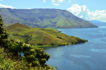 Fototapeta premium Stunning view of the Lake Toba in Indonesia. Beautiful hills lined up. Lake Toba or Danau Toba is a huge crater lake in Sumatra, Indonesia.