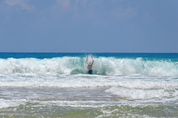 Man inside a big wave. Dangerously strong force of nature.