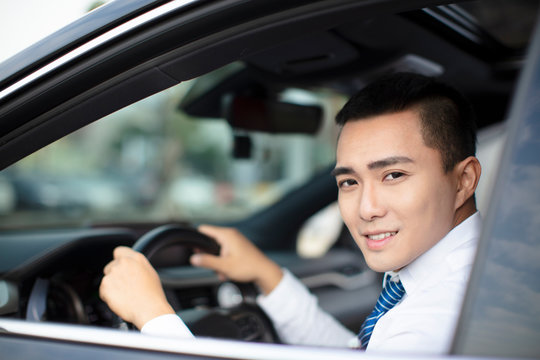 Smiling  Young Business Man  Driving A Car