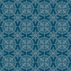 Vector seamless pattern on the theme of nautical travel, adventure and discovery. Wind roses and steering wheels in retro style on a dark blue background