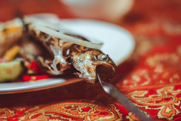 Delicious Asian fish fried on skewers