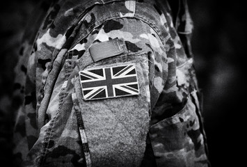 Flag of United Kingdom on soldiers arm. Flag of UK on military uniforms (collage).