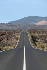 Road going through wilderness area in Timanfaya National Park, Lanzarote, Canary Islands, Spain