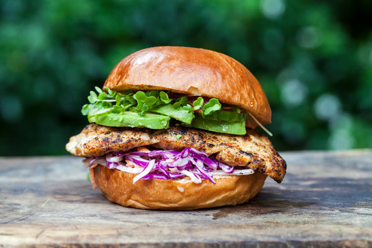 Chicken burger with red cabbage coleslaw and avocado