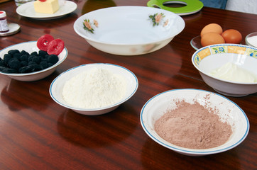 The process of making pie dough by hand. Baking cake in a kitchen dough recipe ingredients eggs, flour, milk, butter, sugar on a table. Sequence, step by step, part of series.