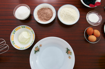 The process of making pie dough by hand. Baking cake in a kitchen dough recipe ingredients eggs, flour, milk, butter, sugar on a table. Sequence, step by step, part of series.
