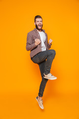 Full length portrait of a cheerful young man