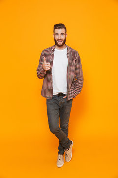 Full length portrait of a cheerful young man